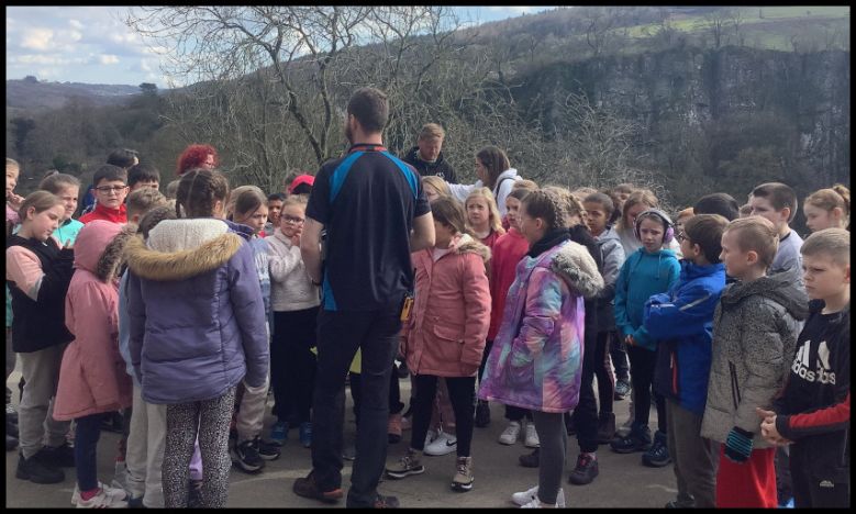 Photo: Staff and Children listening to important instructions.